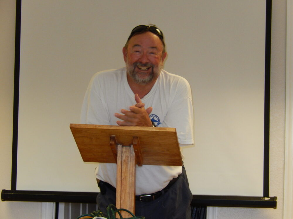 Jeff smiling from a lecturn