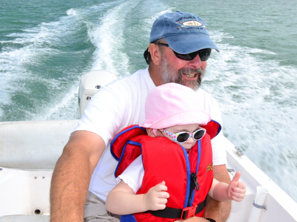 Jeff on a boat with a granddaughter