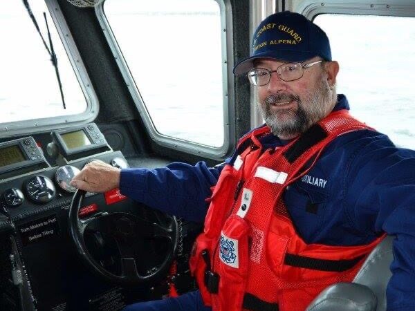 Jeff at the helm of a Coast Guard vessel